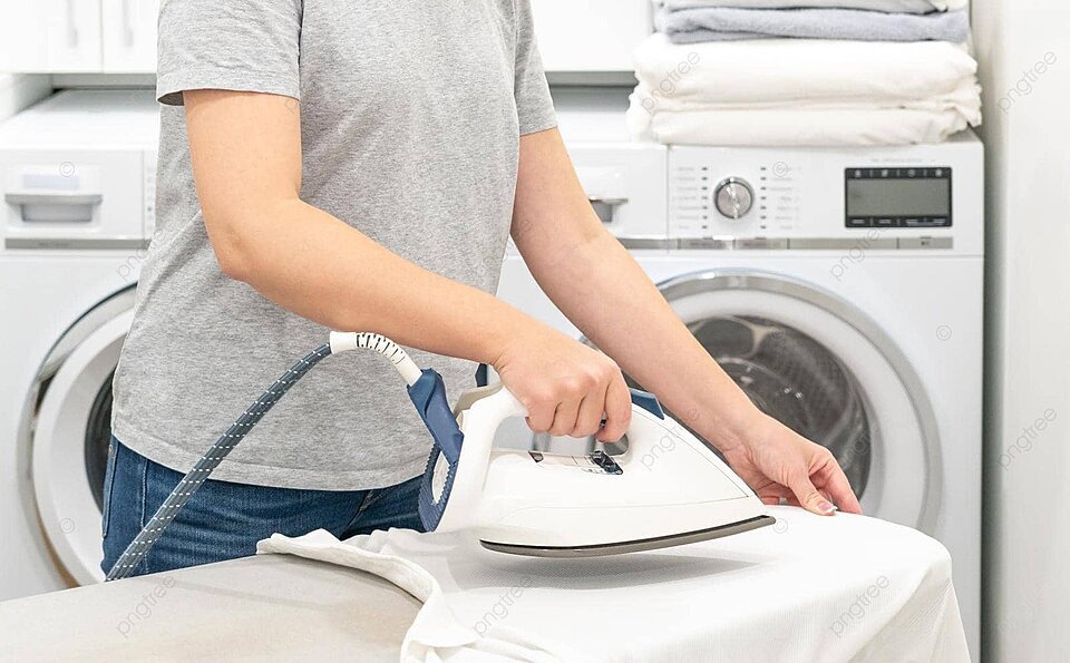 pngtree a lady is ironing a white shirt on an ironing board inside the laundry room with a washing machine in the background photo image 38885888