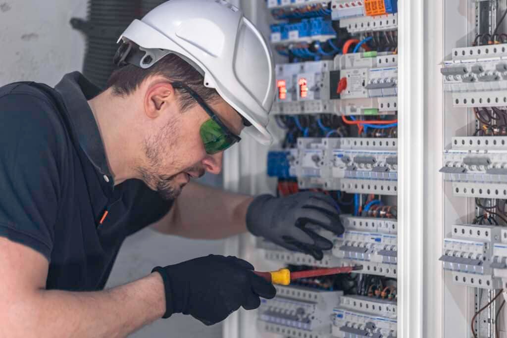 a male electrician works in a switchboard using an 2026 01 08 08 00 52 utc