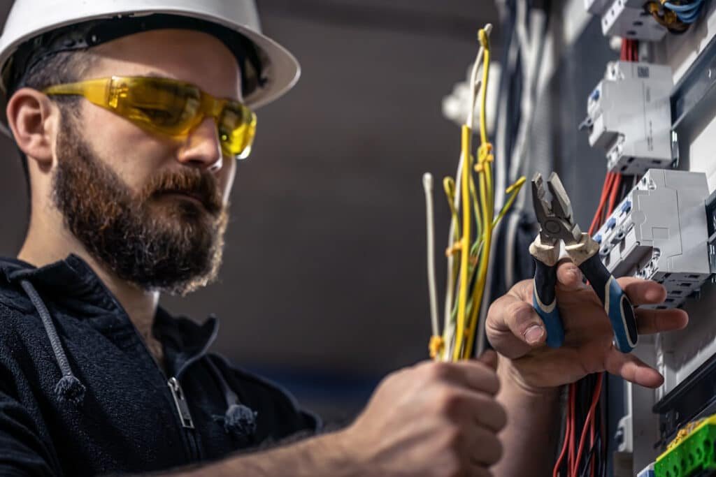 a male electrician works in a switchboard with an 2026 03 25 00 03 10 utc