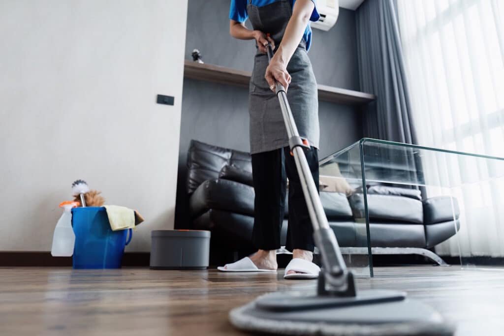 adult mopping wooden floor in home setting 2026 01 08 05 55 08 utc