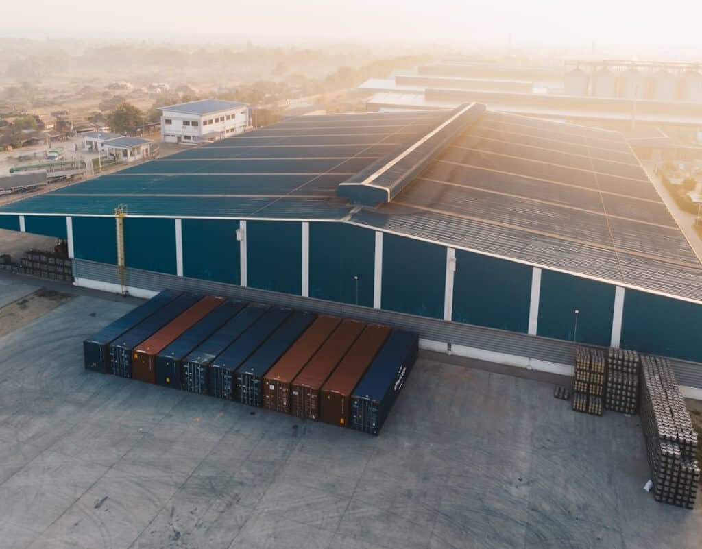 aerial shot of a big warehouse near big metal cont 2026 03 18 07 53 26 utc
