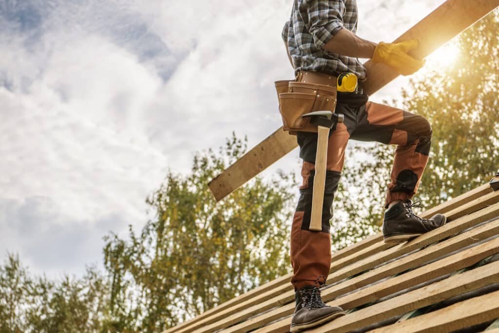building construction site roof worker with a plan 2026 03 20 03 29 59 utc