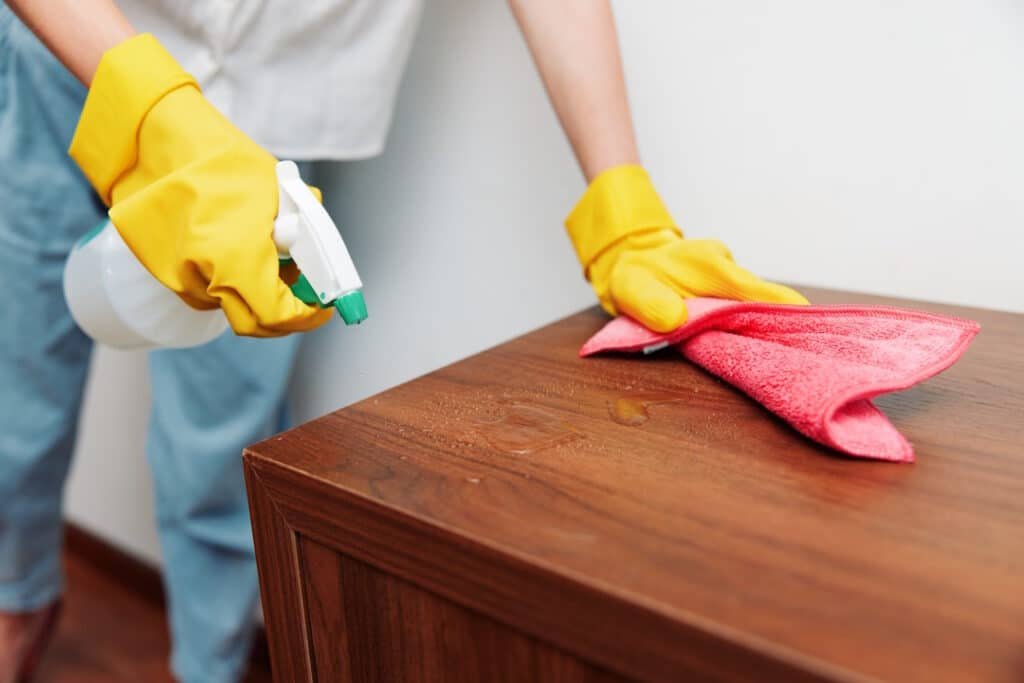 cleaning wooden table with spray bottle and rag 2026 01 09 00 21 21 utc