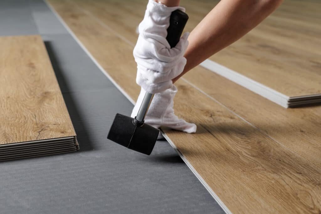 close up aligning spc vinyl plank on underlayment 2026 03 25 10 07 06 utc