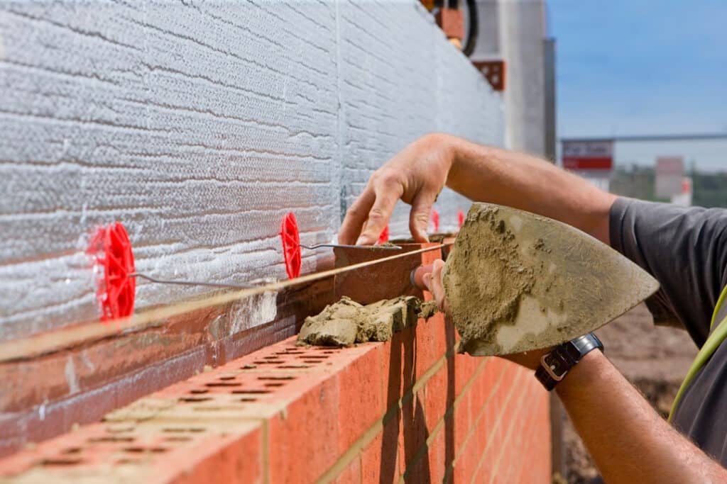 close up of bricklayer laying brick wall on constr 2026 03 26 04 41 20 utc
