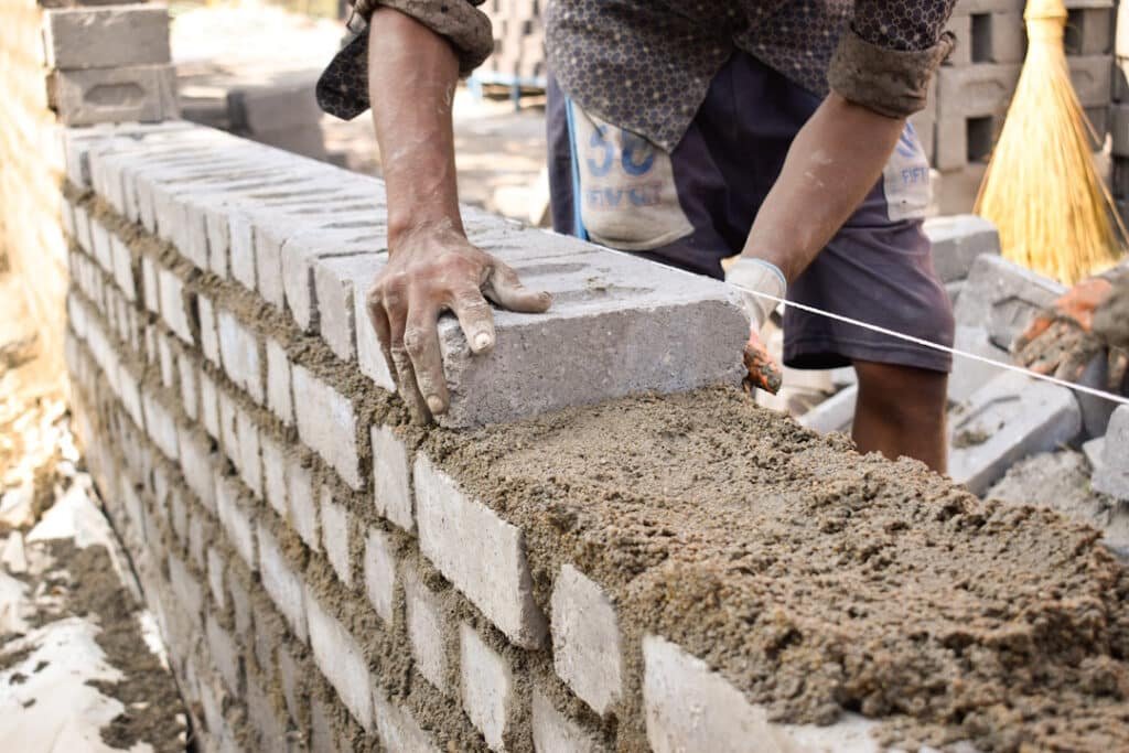 closeup of a man building a brick wall outdoors d 2026 01 07 07 19 55 utc