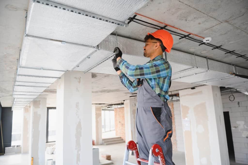 construction worker installing ceiling panels in n 2026 03 27 02 07 29 utc (1)