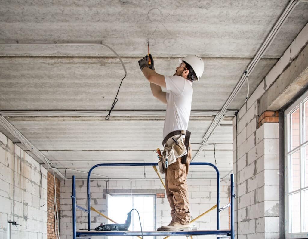 construction worker installs wiring in new buildin 2026 03 23 23 46 24 utc