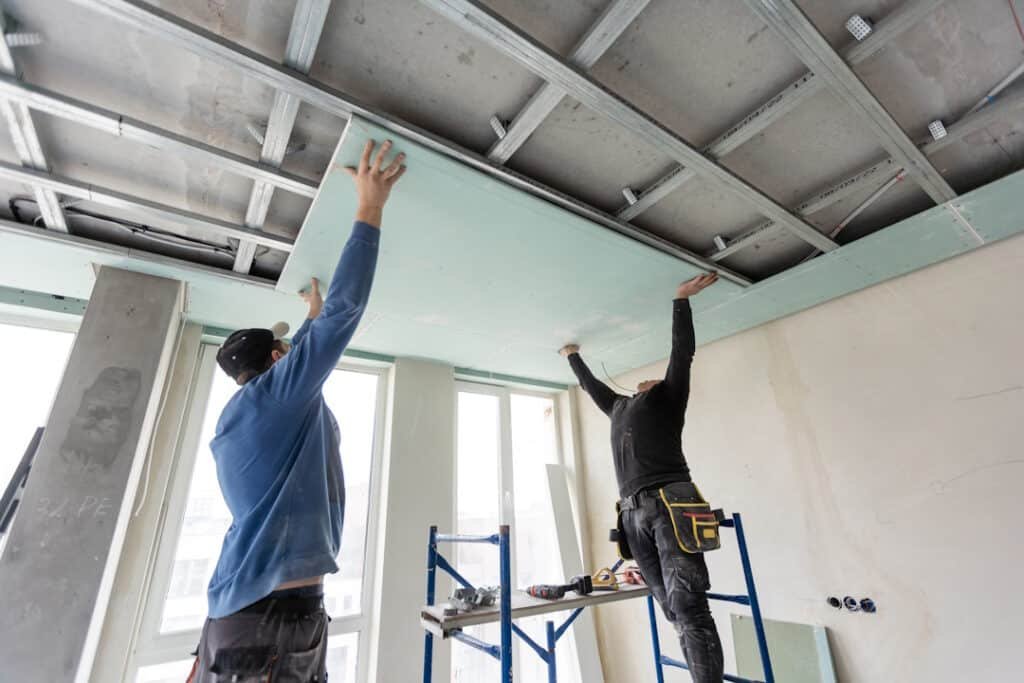 construction workers installing drywall in an urba 2026 03 17 07 23 58 utc