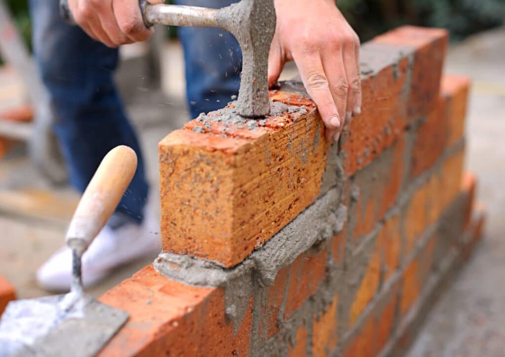 craftsman building brick wall with hammer and trow 2026 03 25 01 30 49 utc