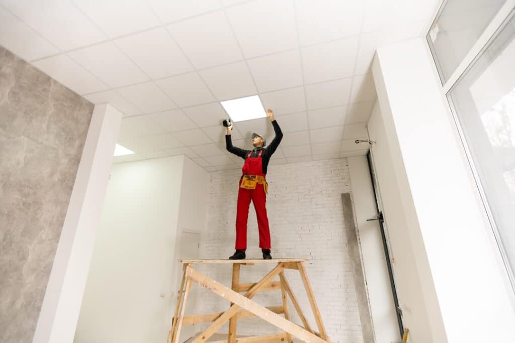 builder replacing ceiling panel, working, ceiling armstrong.