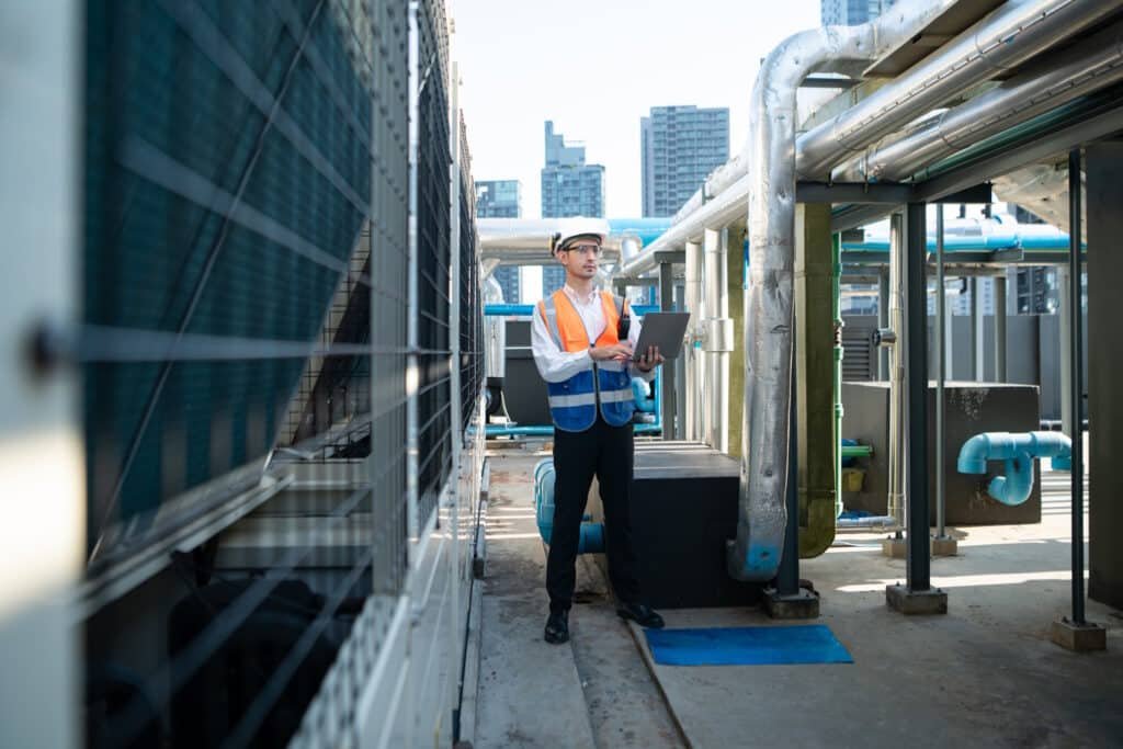 engineer inspecting cooling system on building roo 2026 01 07 02 30 50 utc
