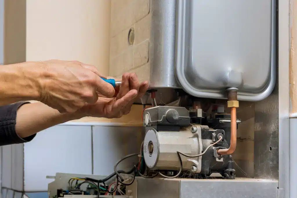 hands working on household heater repair 2026 03 18 04 21 35 utc