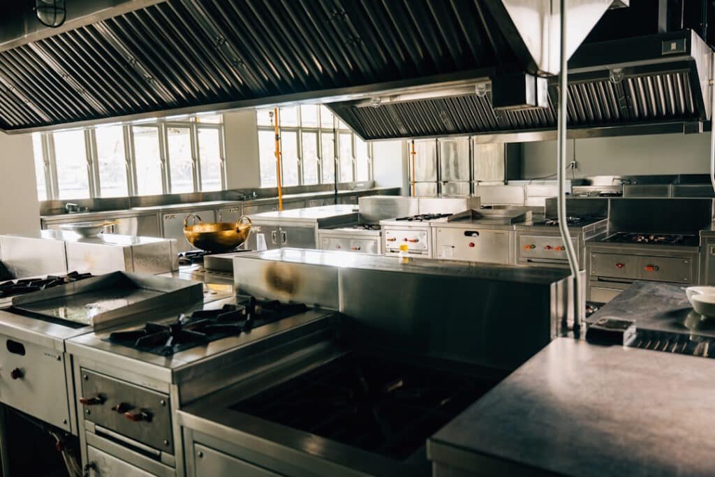 a commercial kitchen with stainless steel appliances and counters
