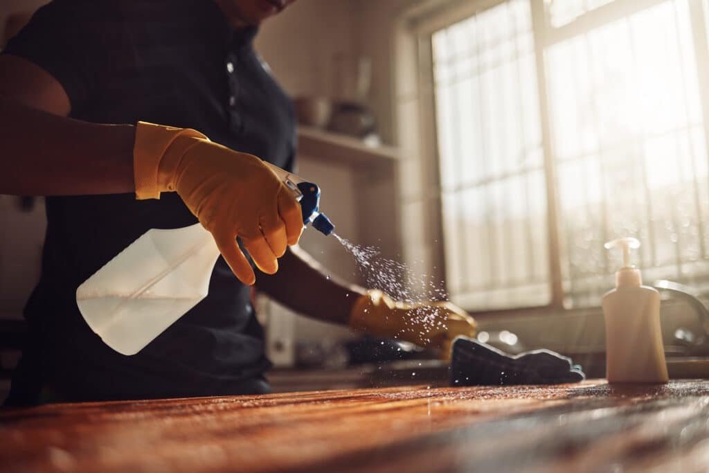 person cleaning a wooden surface with spray bottle 2026 01 09 09 43 20 utc