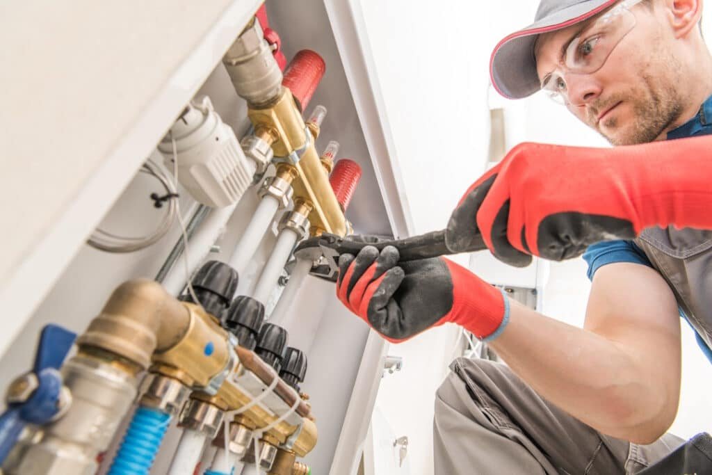 plumber repairs pipes with a wrench at work 2026 03 24 06 20 36 utc