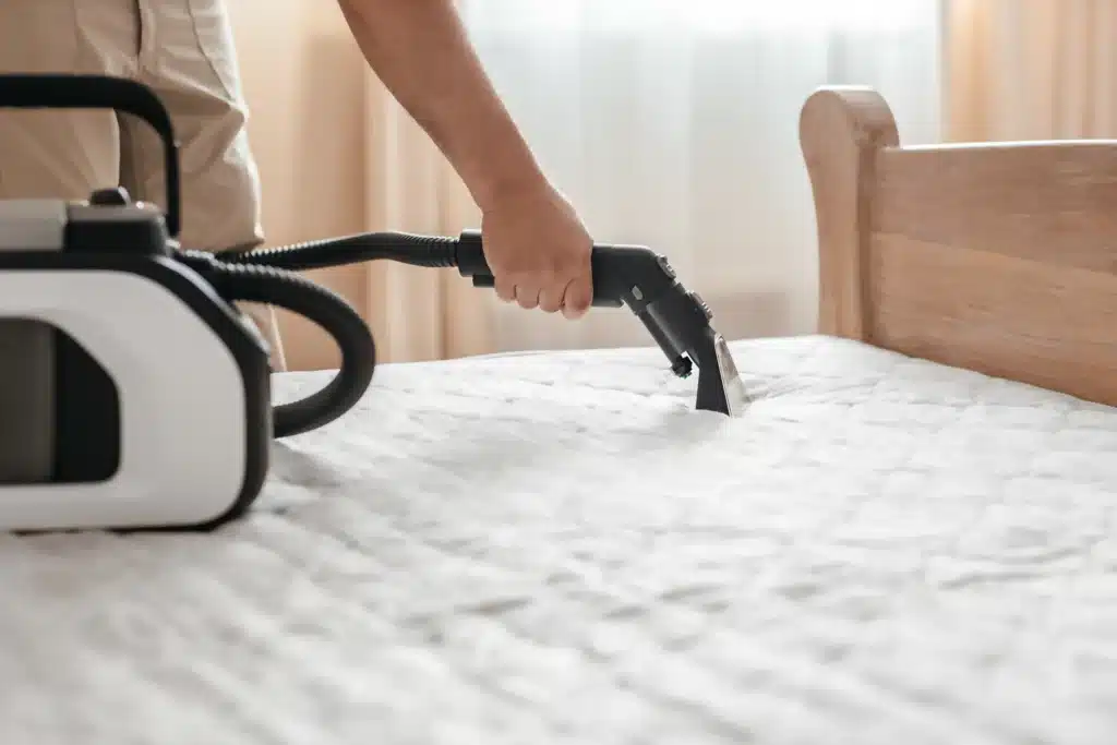 professional male cleaner vacuuming a mattress in 2026 07 08 20 13 34 utc