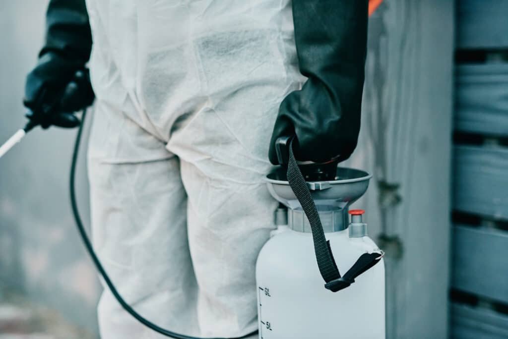 protective suited worker disinfecting area with sp 2026 03 25 08 20 17 utc