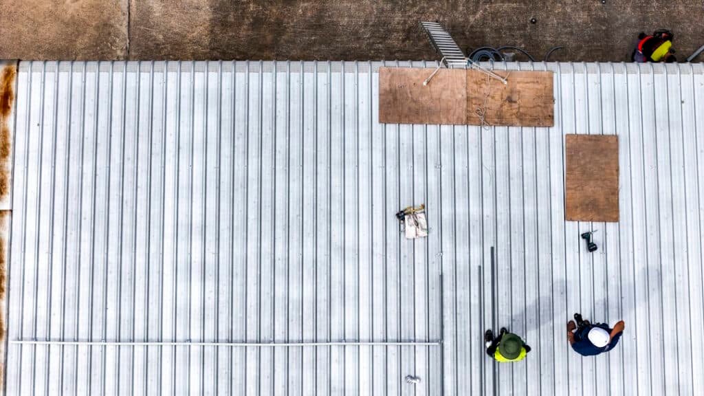 roof repair by construction workers from above 2026 03 25 09 02 55 utc