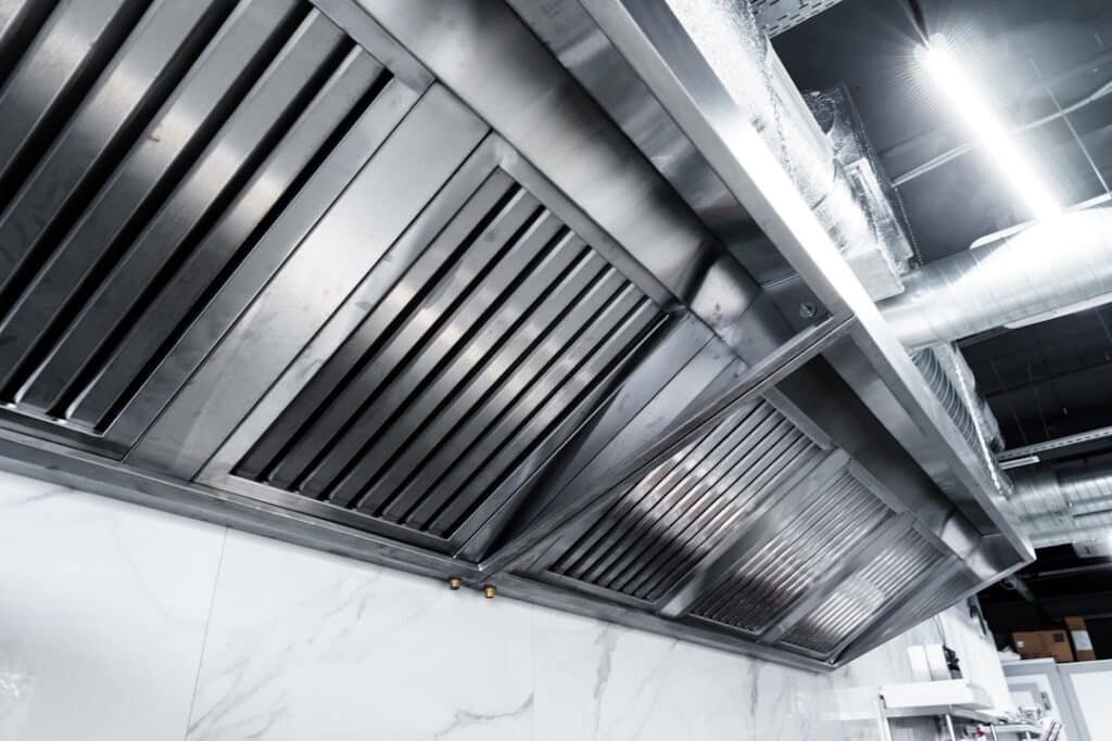 new clean stainless steel hood in professional kitchen close up