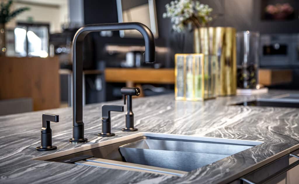 black faucet with a steel sink in a stylish modern kitchen.