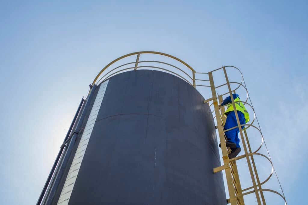 south africa, cape town, construction worker climbing up ladder