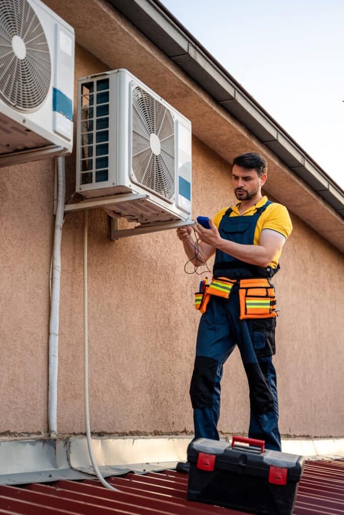 technician fixing air conditioning unit on buildin 2026 03 08 22 57 32 utc