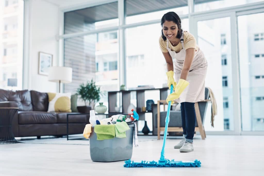 woman mopping floor in bright modern apartment 2026 01 09 09 49 50 utc